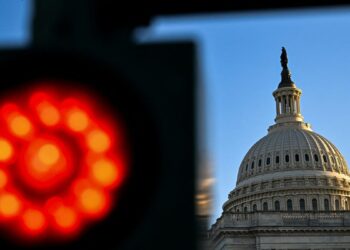 The current government shutdown, dubbed the “nuclear war of shutdowns,” has a more significant impact on federal jobs and grants compared to previous ones. President Trump is using this opportunity to freeze billions in federal grants to Democratic states and threaten layoffs among federal workers.